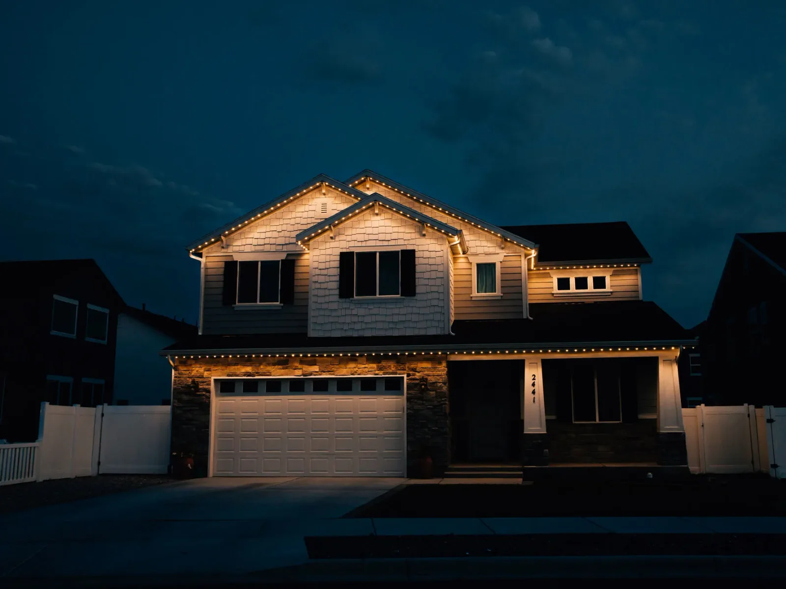 CHIPR LUX permanent roofline lighting on a Draper home at dusk — warm white Z8A hero shot