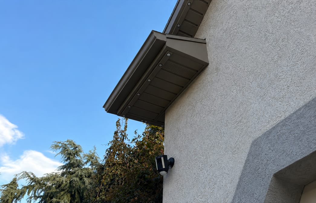 Low-angle view of the color-matched brown soffit corner return with discreet recessed lights