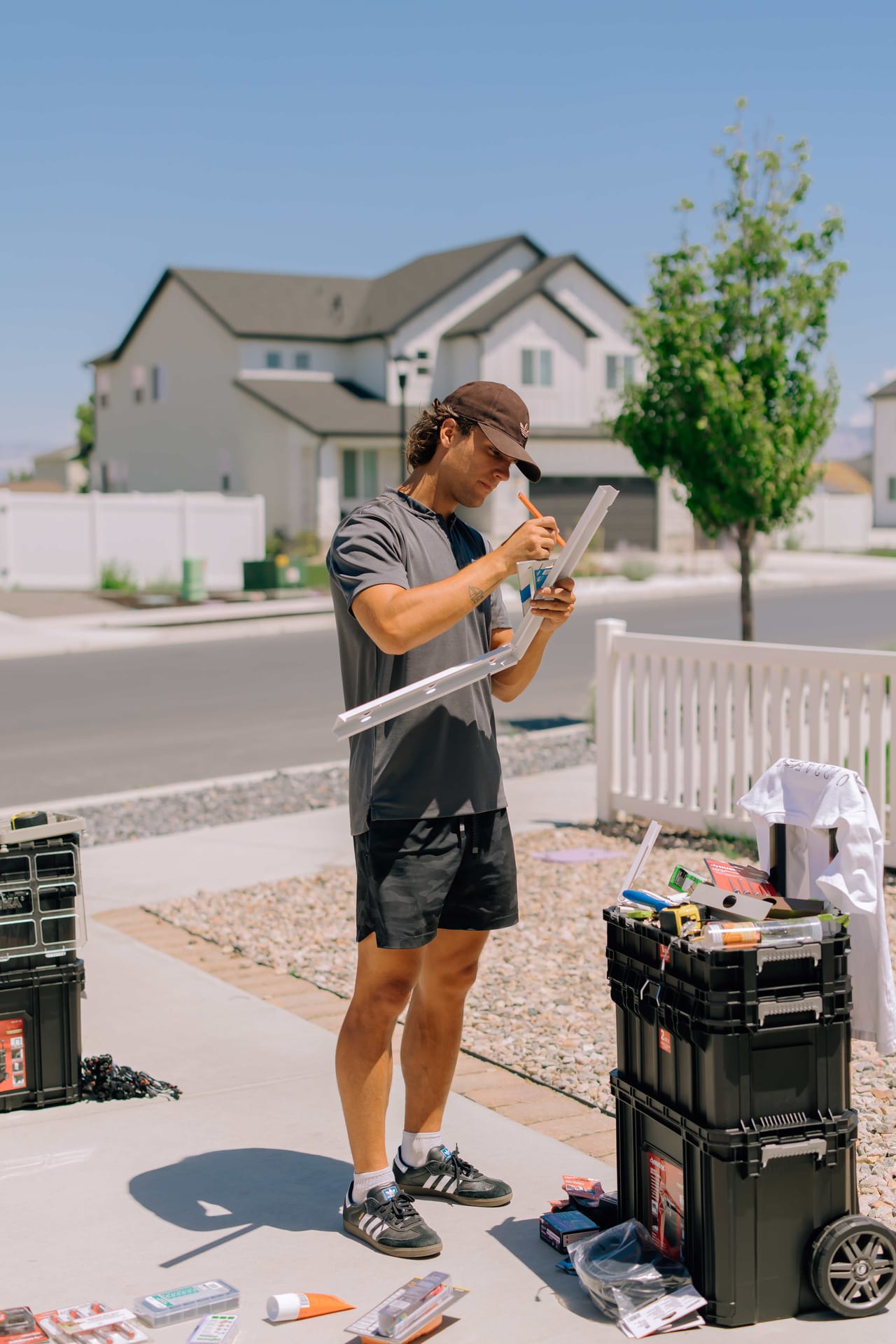 Chipr technician marking an aluminum track section for a custom cut on the driveway